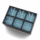 Close-up of black silicone ice tray with engraved M&V and EST 2018 ice cubes, perfect for romantic celebrations and wedding gifts