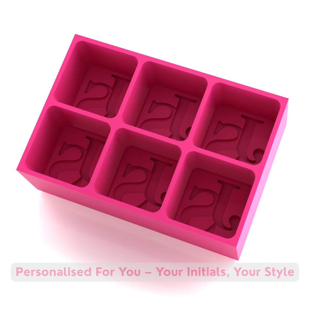 Bright pink silicone ice cube mold with raised letter initials for creating personalized ice cubes