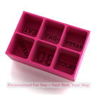 Pink silicone mold with letter impressions on a white background