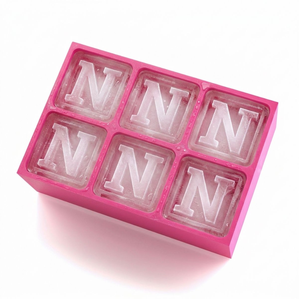 Vibrant pink ice tray with six monogrammed cubes, all displaying the letter N. Stylish, handmade Australian gift for milestone birthdays, weddings, or girls’ nights.