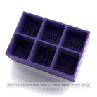 Purple silicone mold with engraved text on a white background