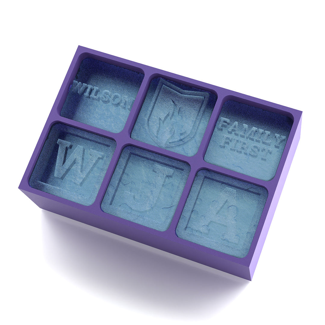 Purple ice cube tray featuring a crest, initials, and the words ‘Family First’ – designed to symbolise pride in the Wilson family heritage.