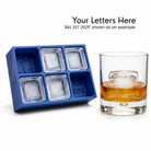 Blue R&L Est 2025 monogrammed silicone ice cube tray with ice cubes next to a whisky glass holding a personalised ice cube