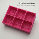 Pink R&L Est 2025 personalised silicone ice cube tray, top view of the monogram and EST 2025 embossed moulds