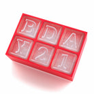 Red ice cube tray with 'BDAY21' custom letters, ideal for fun birthday drinks and cocktails.