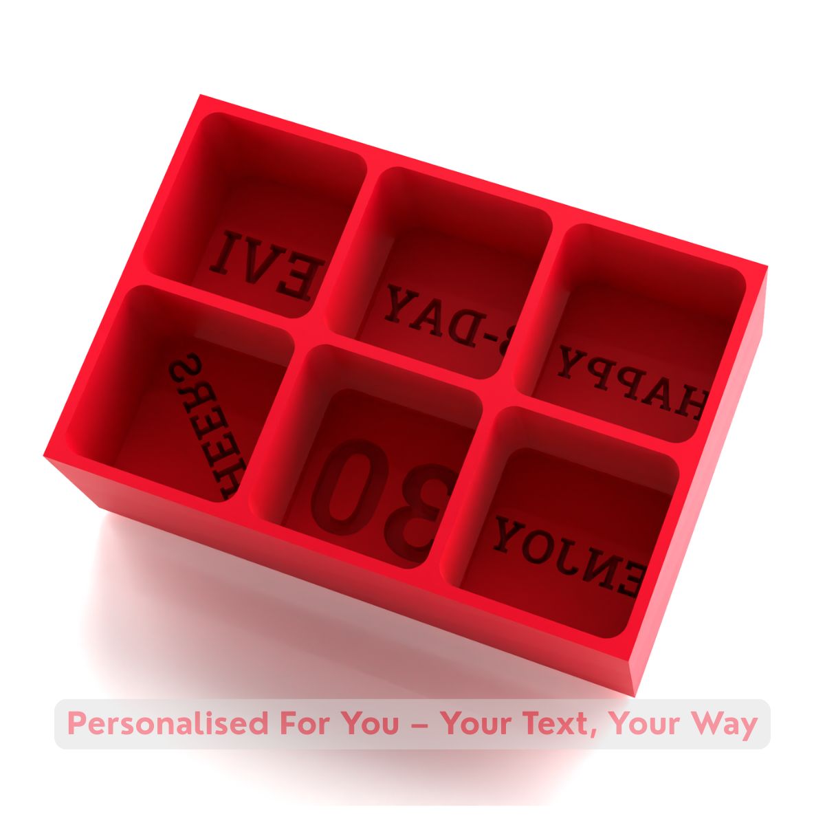 Red silicone mold with letter impressions on a white background