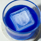 Square ice cube with raised U monogram in a vibrant blue drink, set in a modern glass – ideal for birthday parties, personalised gifts, or memorable cocktail moments.