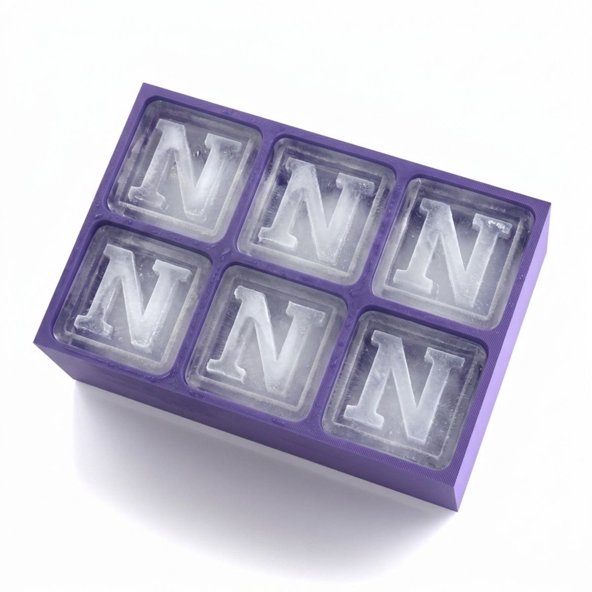 Purple silicone ice tray holding six ice cubes, each frosted with a raised letter N. Personalised and handmade, ideal for celebrations, parties, and keepsake gifts.