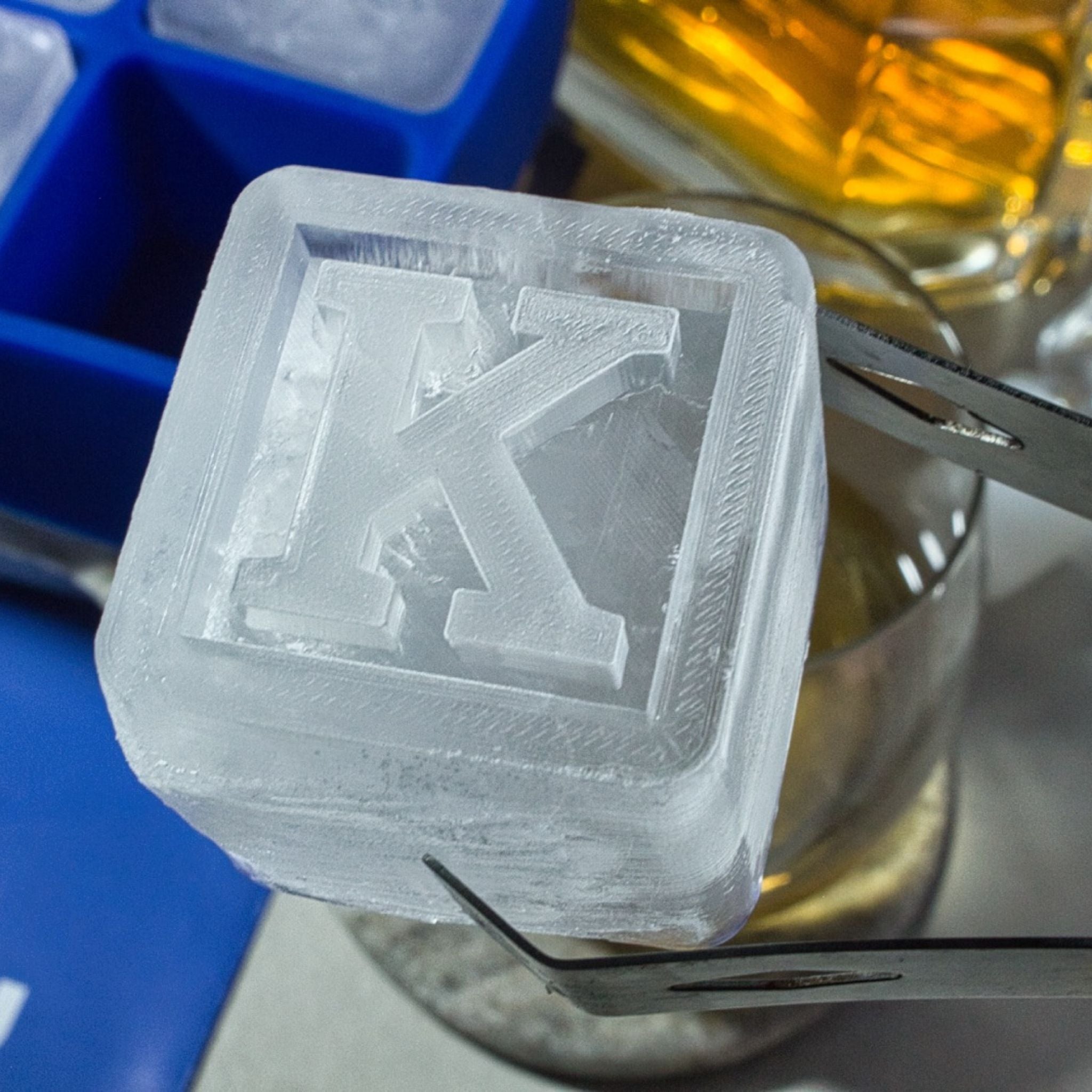 Extreme close-up of an K-shaped ice cube, showing detail and clarity, ideal for showcasing quality