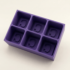 A purple silicone mold with six compartments, each containing a recessed letter 'C', shown on a clean off-white background.