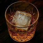 Custom monogrammed ice cube in a whiskey glass showing crisp embossed initials